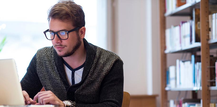 A male researcher working on a laptop.
