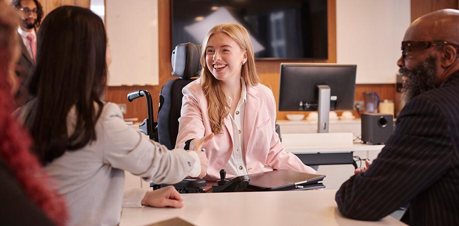 A female job interview candidate meeting interviewers.