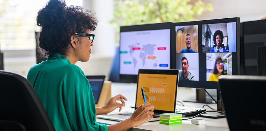 Female tutor discussing work with students on a video call.