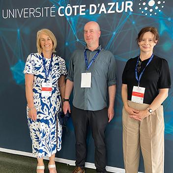 Three Jisc staff members at an event.