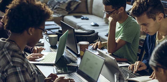 Students studying together on laptops