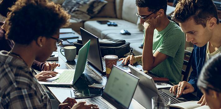 Students studying together on laptops