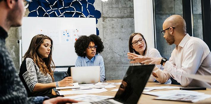 Work colleagues in discussion during a meeting.
