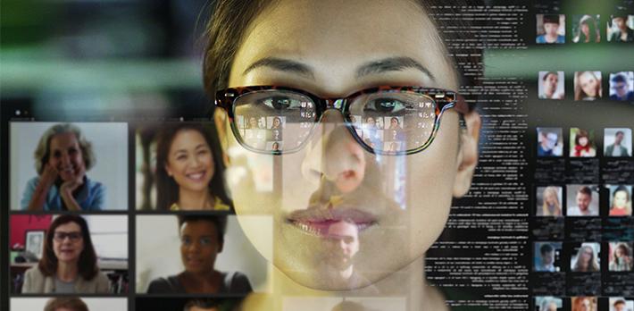 A woman looks at data on a screen.