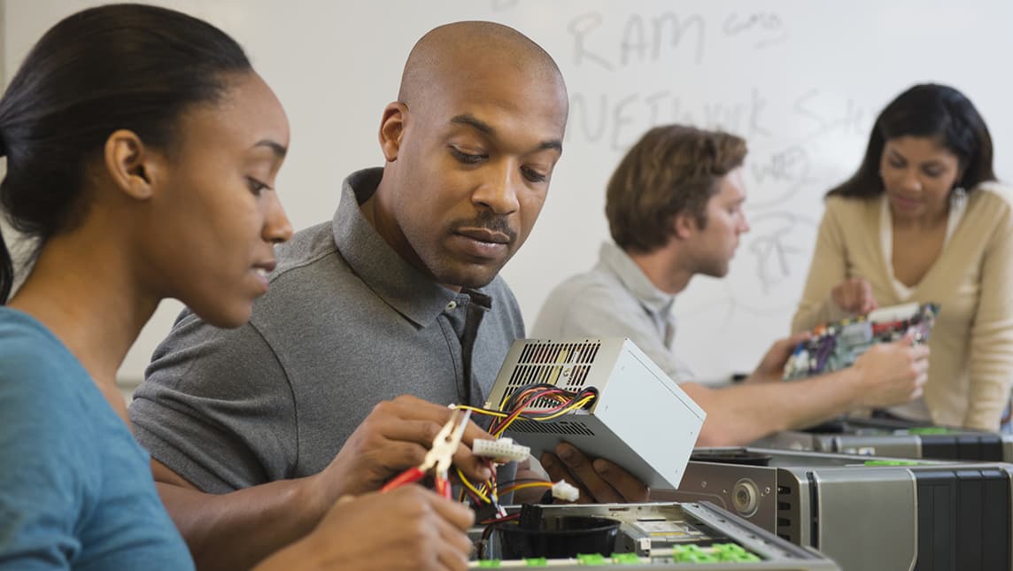 Students working on electrical equipment.