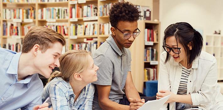 four-further-education-students-in-a-library-generic