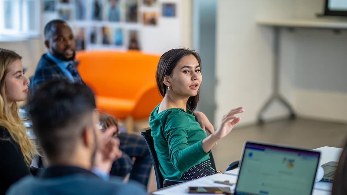 Group of students sitting at tables in a classroom
