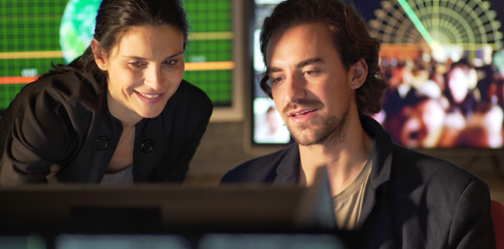 Colleagues discussing data on their computer