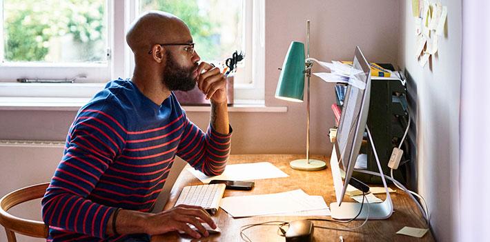A researcher completes paperwork in their home office.