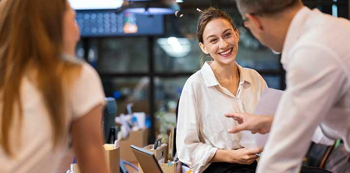 Colleagues in discussion in the workplace.