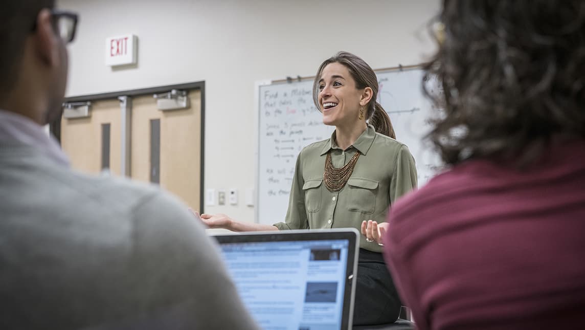 woman talking with students