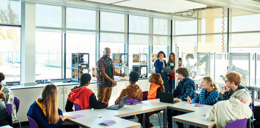 Technical college tutor talking to students in class