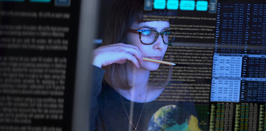 A female computer technician looking at a screen.