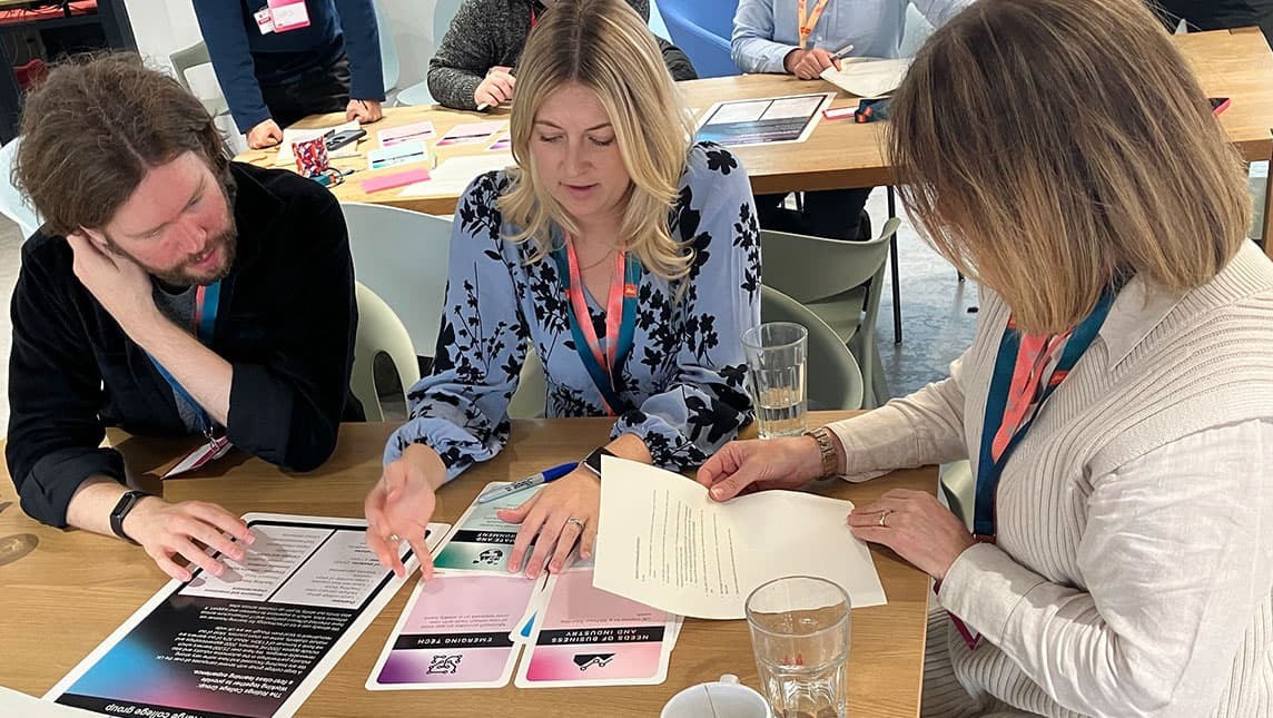 Three representatives from FE colleagues use prompt cards to discuss the future of education.