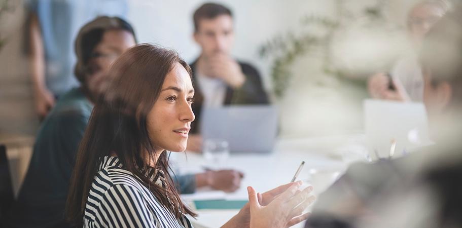 A female staff member talking in a meeting.