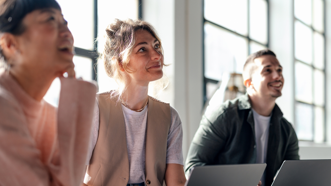 Young professionals collaborating in modern co-working space.
